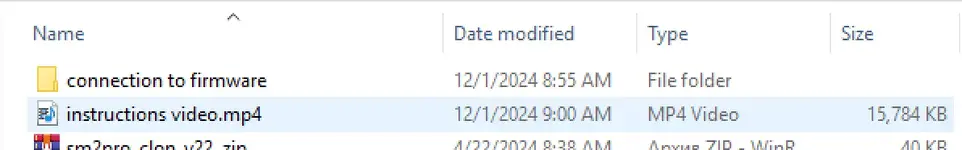A folder containing an instructional video (instructions video.mp4) and firmware connection files for the Scanmatik 2 diagnostic tool.